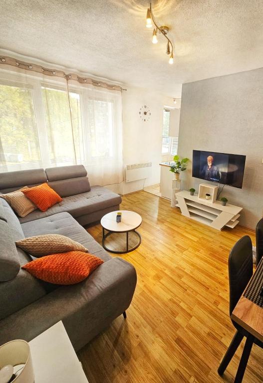 a living room with a couch and a table at Apartman Gnječ Kupres in Kupres
