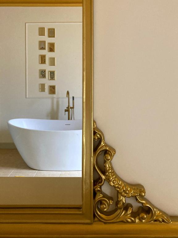 a bathroom with a white tub and a mirror at La Trita Dimore di Charme in Bussi sul Tirino
