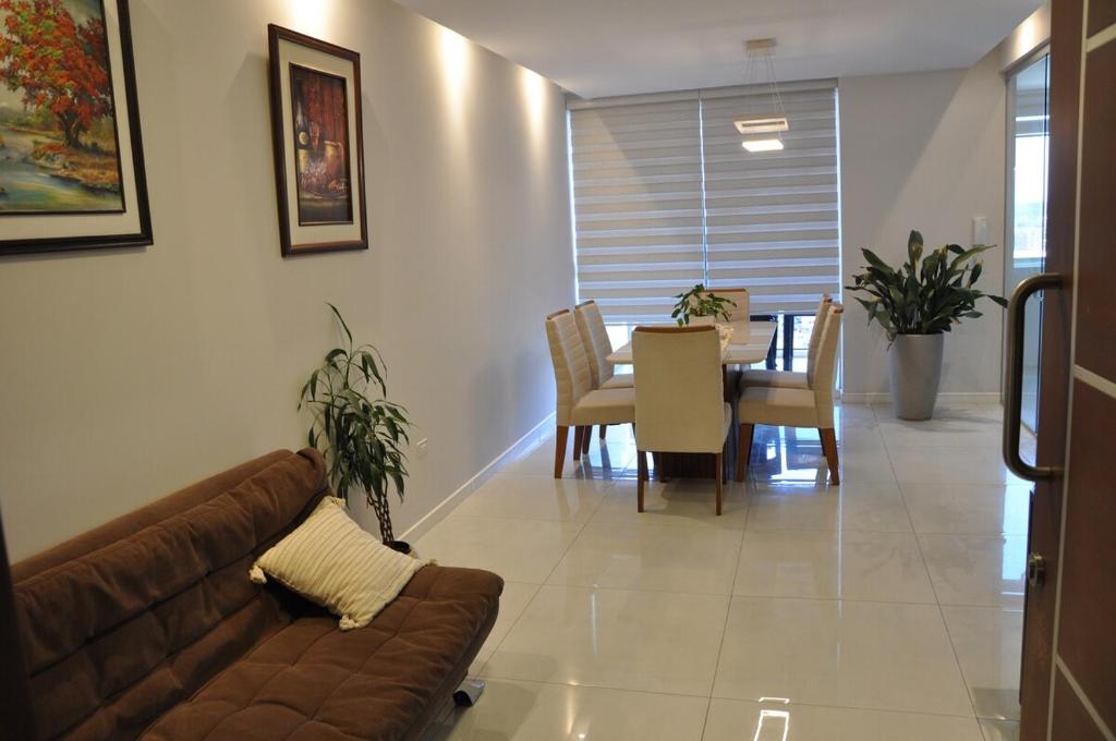 a living room with a couch and a dining room at Condo en Cochabamba in Cochabamba