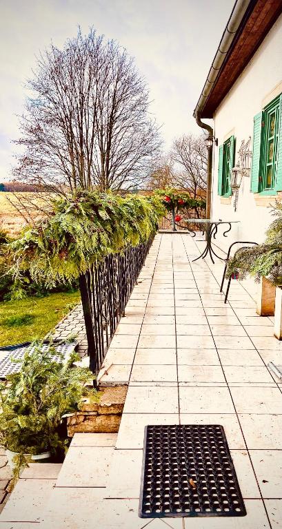 a sidewalk with a fence and a bench on it at Sancta Katharina in Rozvadov