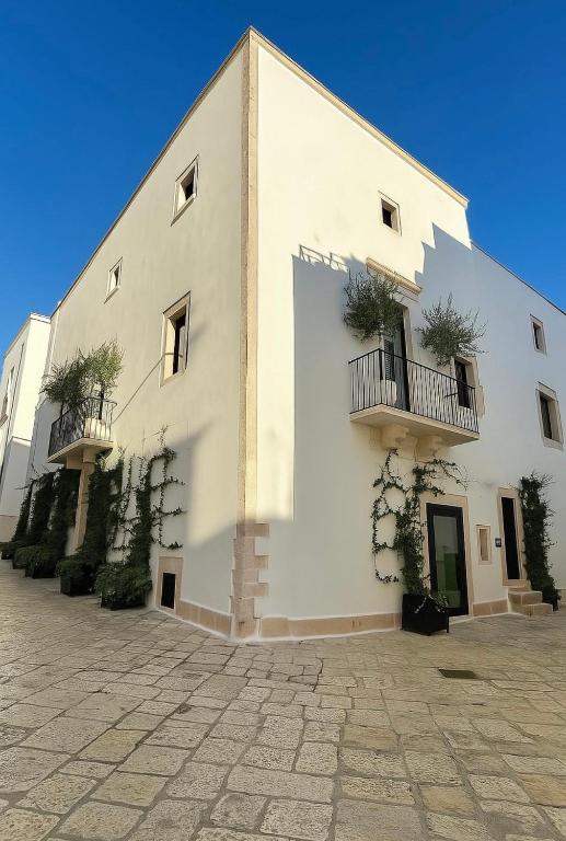 a white building with two balconies on the side of it at Dimora San Nicola Charming Suite in Conversano