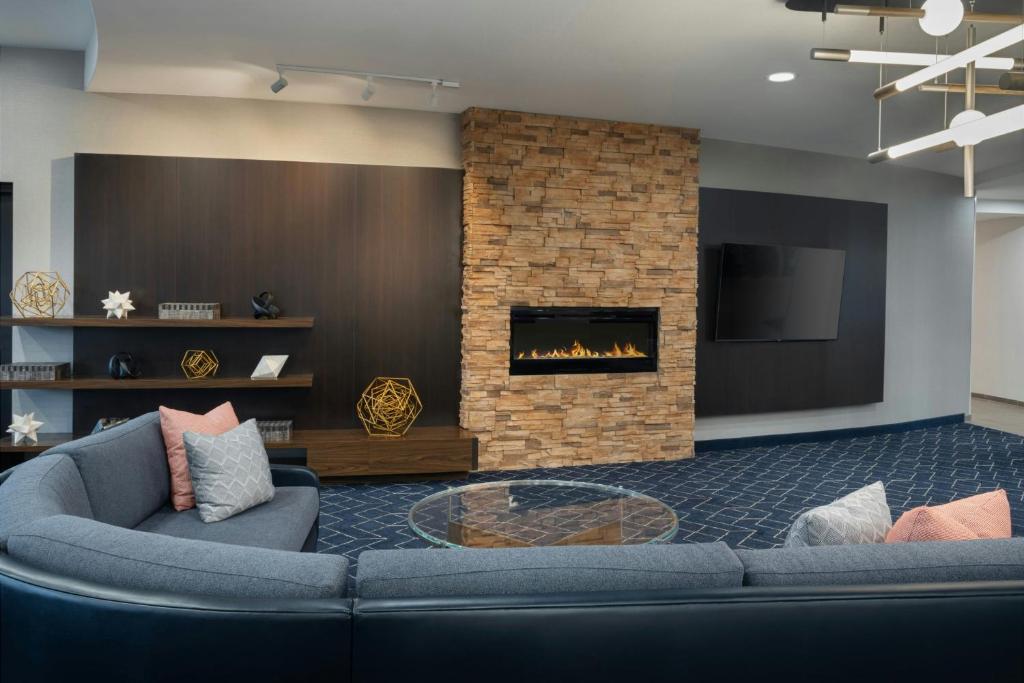 a living room with a couch and a fireplace at Courtyard Casper in Casper
