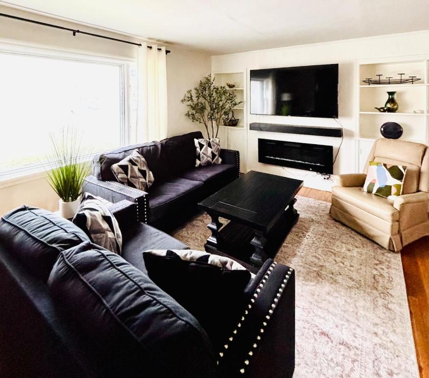 a living room with a couch and a table at Entire home, 6 min drive to UIUC in Champaign