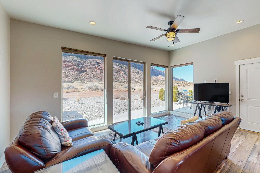 a living room with a couch and a flat screen tv at Rim View 7 in Spanish Valley
