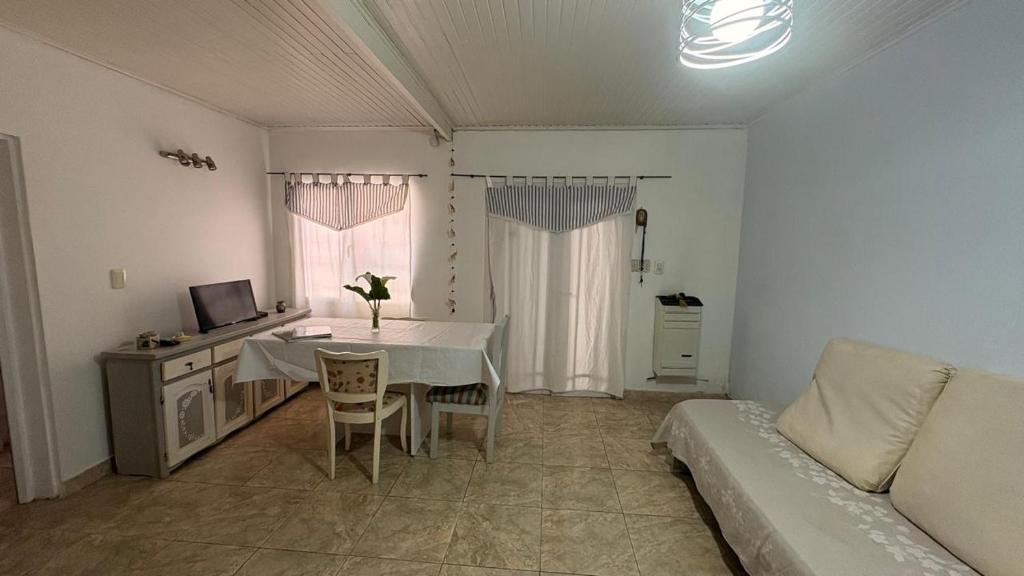 a living room with a table and a couch at alaguthe in Olavarría