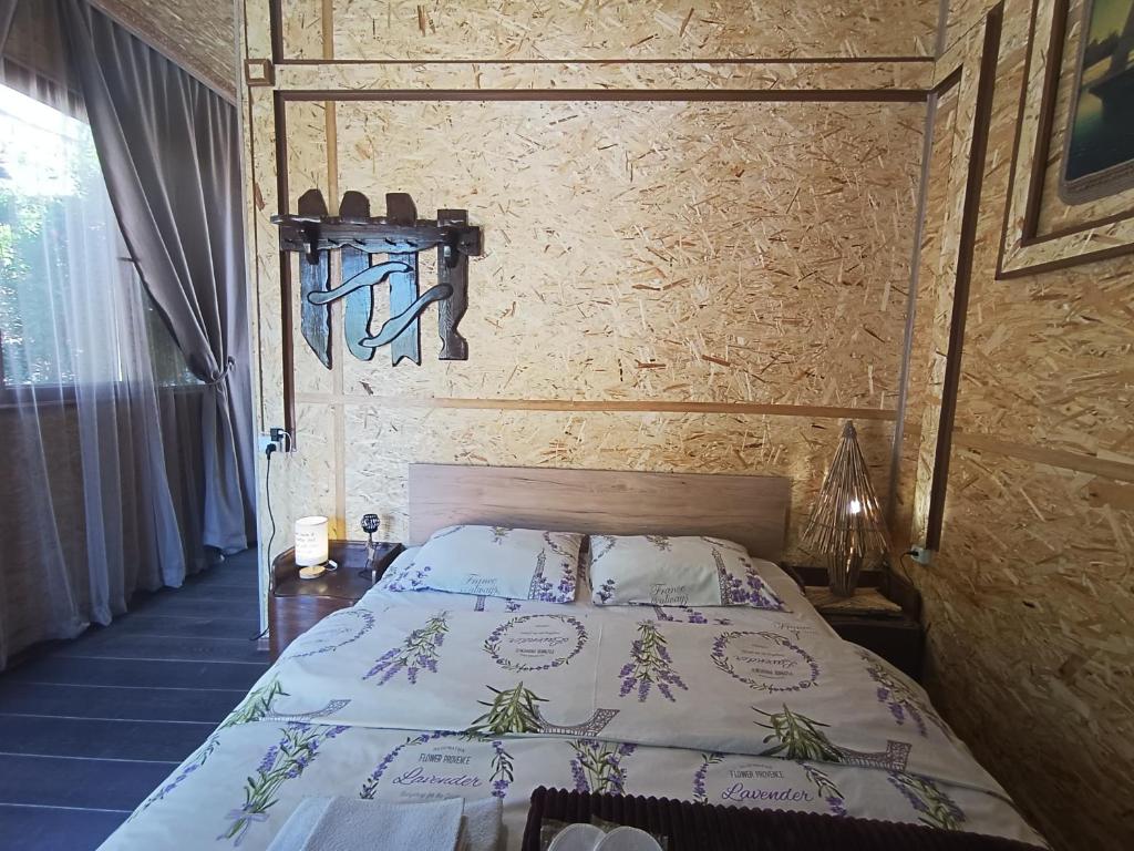 a bedroom with a bed and a wall at Tevosyan Gold EVN Airport in Pʼarakʼar