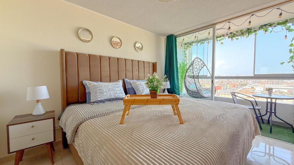 a bedroom with a bed with a table on it at Nuevo departamento con vista al mar y piscina-Pool One in Lima