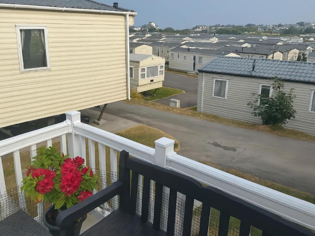 a balcony of a house with a flower pot on it at Brynowen Holiday Park - Holiday Accommodation 19041 in Borth