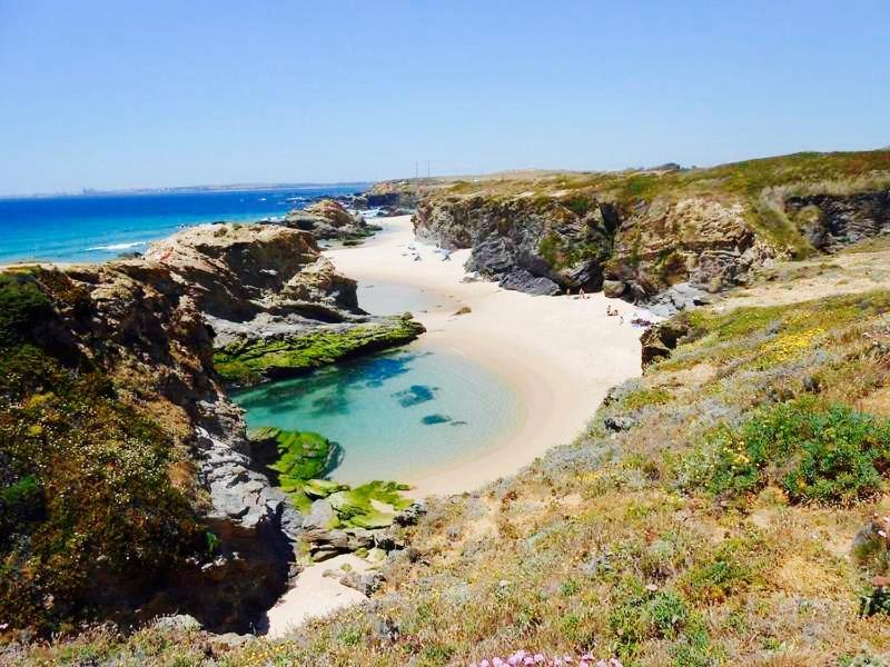 a beach on the side of a rocky cliff at Monte do Espadanal in Cercal