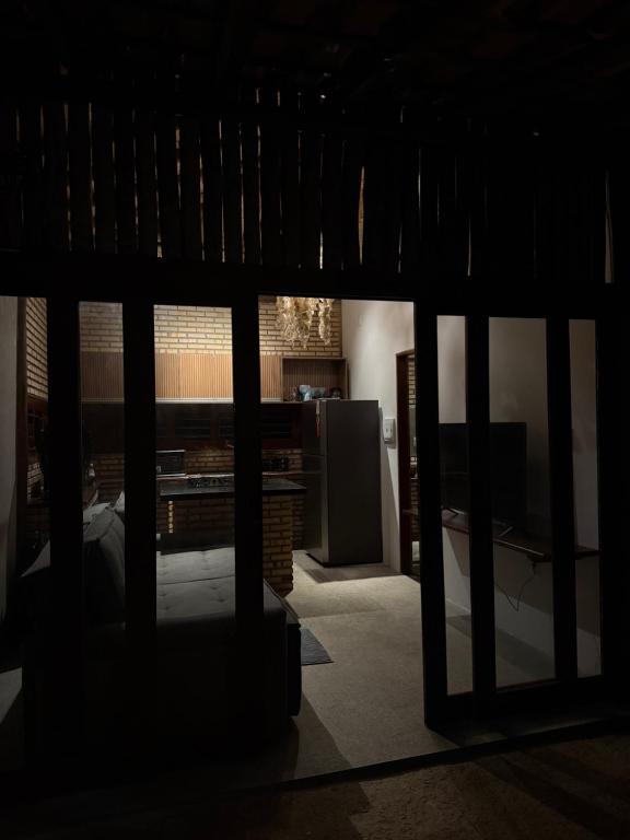 a view of a living room with a tv in a room at Bangalô raizes in São Gonçalo do Amarante