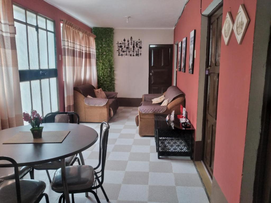 a living room with a table and a couch at Casa Hospedaje in Ayacucho