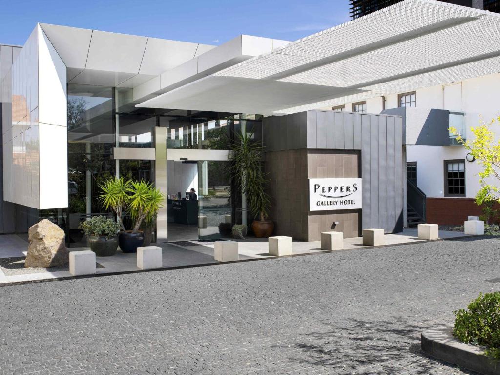 a building with a sign on the side of it at Peppers Gallery Hotel in Canberra