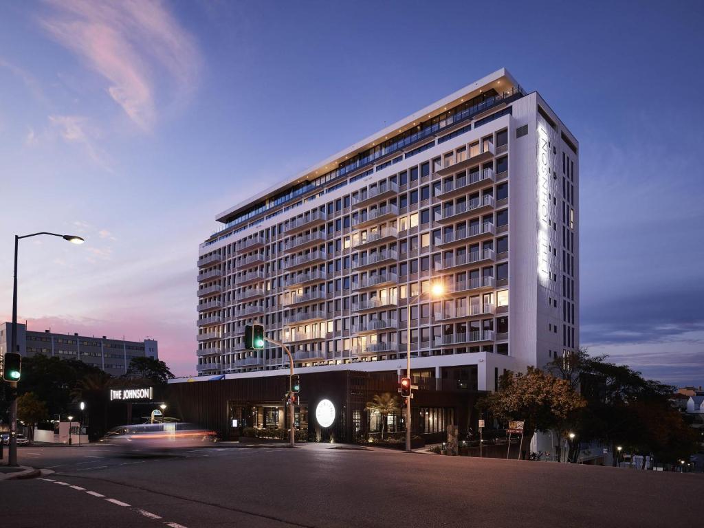 a large building on a city street at night at The Johnson Brisbane - Art Series in Brisbane