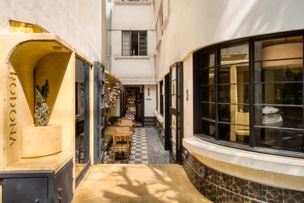 an empty street with a building with windows at Rodona Hotel in Mexico City