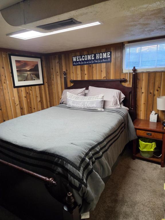 a bedroom with a bed with a welcome home sign at Cozy Hideaway in Lewiston