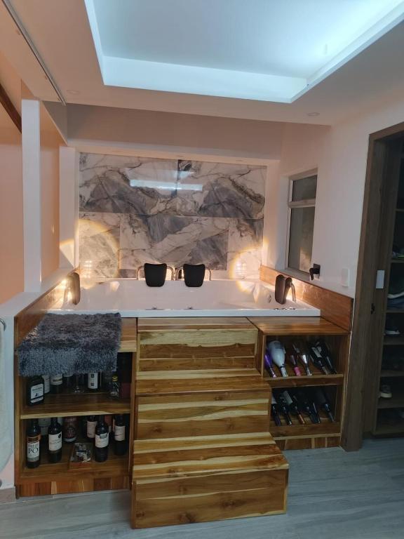 a kitchen with a counter with wine bottles at Penthouse with Jacuzzi in Guarne in Guarne