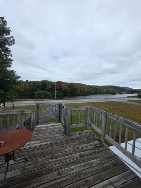a wooden deck with a table and a table at Bingham Motor Inn in Bingham