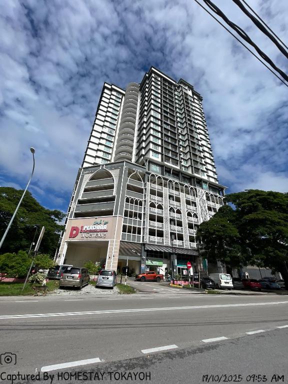 a tall building with cars parked in front of it at TOKAYOH D Khadijah in Kota Bharu