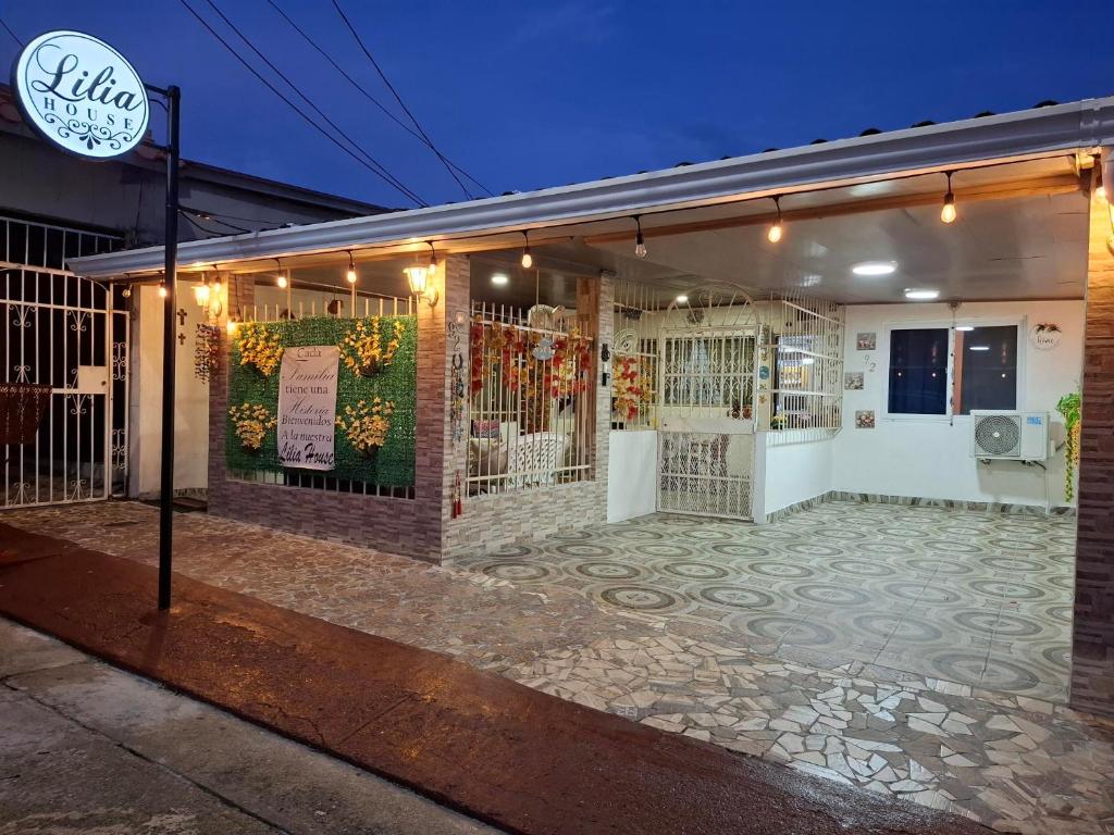 a building with a fence and a sign on it at Casa Lilia Airport in Panama City