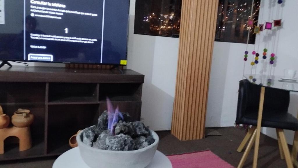 a room with a bowl of rocks on a table at The heart of Tawa Wawa Wasi in Cusco