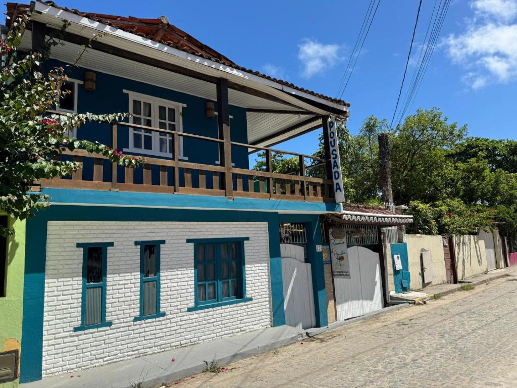 a blue and white house on the side of a street at Recanto D'Ajuda in Arraial d'Ajuda