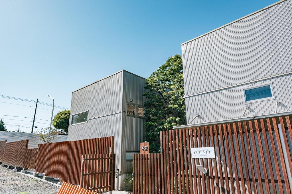a building with a fence in front of it at Fuji Private Villa FUU-KUU in Fujiyoshida