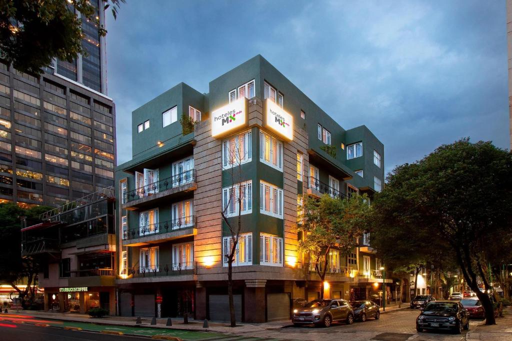 a tall building with cars parked in front of it at Hotel MX mas reforma CDMX, Trademark Collection by Wyndham in Mexico City