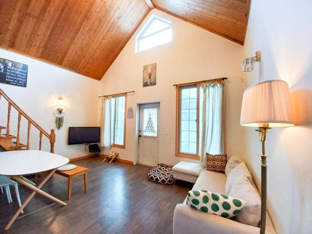 a living room with a couch and a table at Hongcheon Riverhill Stay in Torung-gol