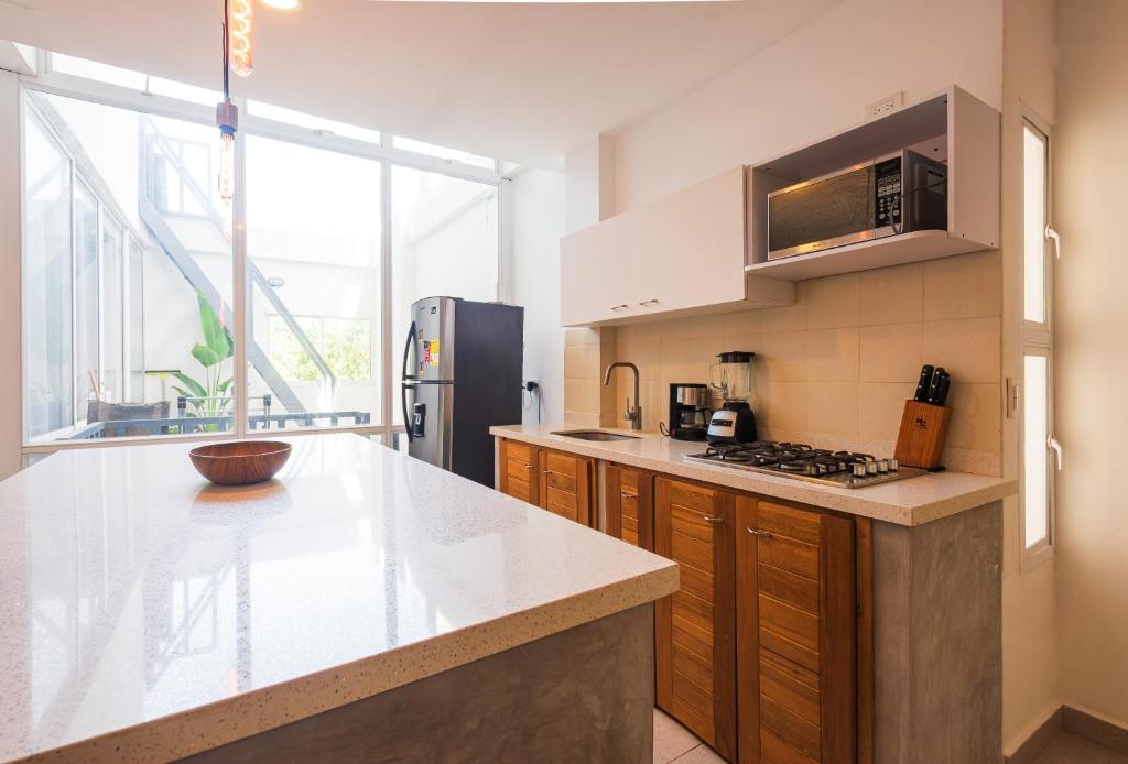 a kitchen with a counter top and a refrigerator at Casa Bacoba in Santa Marta