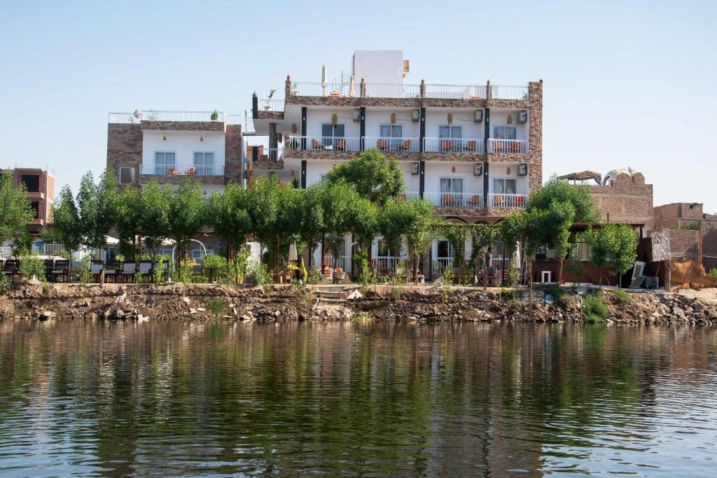 a building on the side of a body of water at Lake House Hotel in Luxor