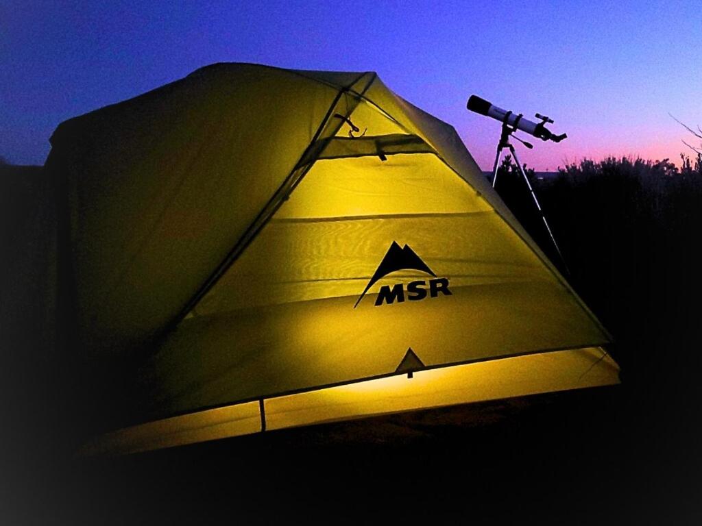 a lit up tent with a camera on a tripod at Campkit - Premium Camping Kit, Pickup in Kanab - Camp Anywhere in Kanab