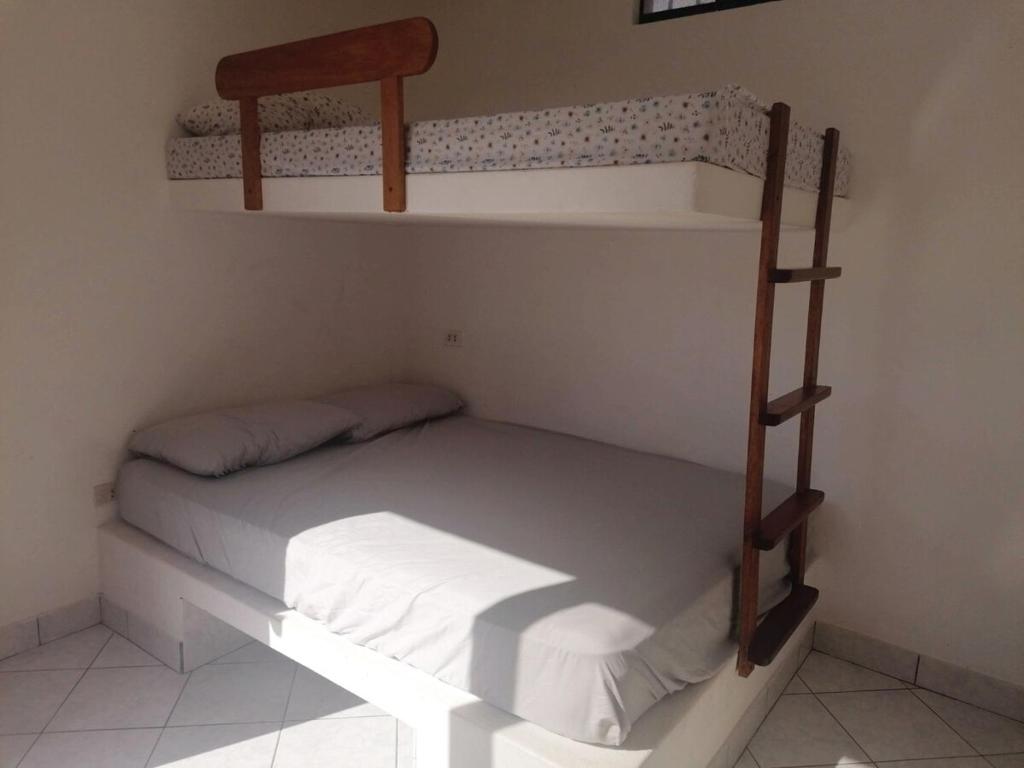 a bedroom with two bunk beds in a room at Casa de Playa en Lobos in Cerro Azul