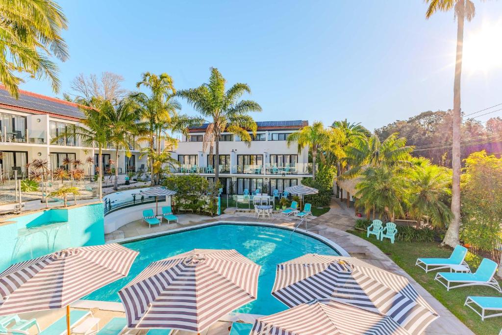 an image of a resort swimming pool with umbrellas at Terrigal Pacific Coastal Retreat in Terrigal