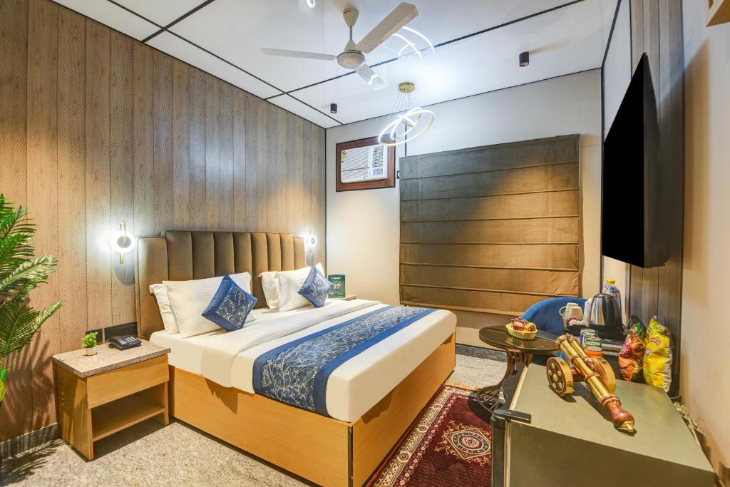 a hotel room with a bed and a tv at JS Residency Luxe Collection Hotel Near Nizamuddin Railway Station in New Delhi