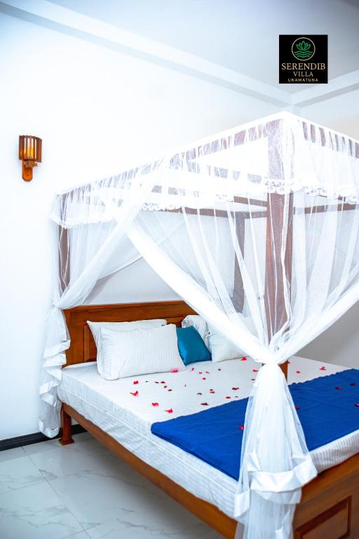 a bedroom with a bed with a canopy at Serendib villa unawatuna in Unawatuna