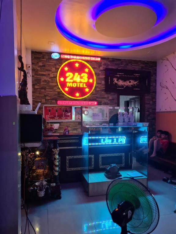 a restaurant with a fan and a neon sign at Hotel Long Thành 243 - 酒店 in Long Thành