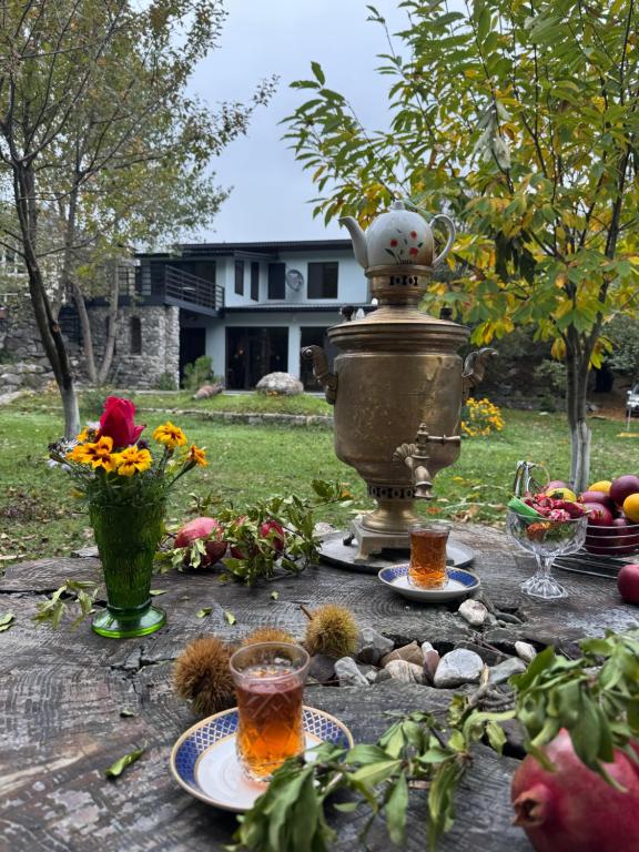 a table with plates of food and a pot with a drink at Istisu Valley Spa in İsmayıllı