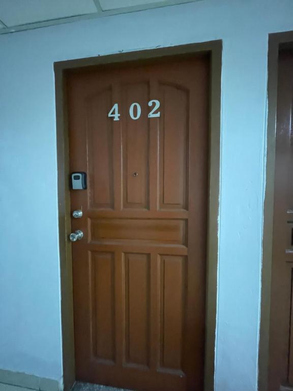 a brown door with the number on it at Harmony Transient in Baguio