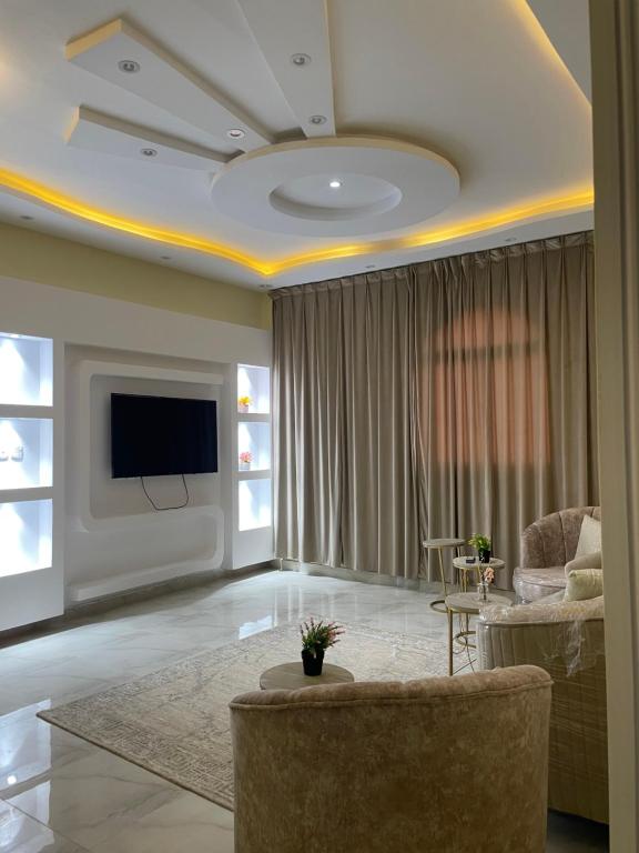 a living room with a couch and a tv at alula apartment in Quai