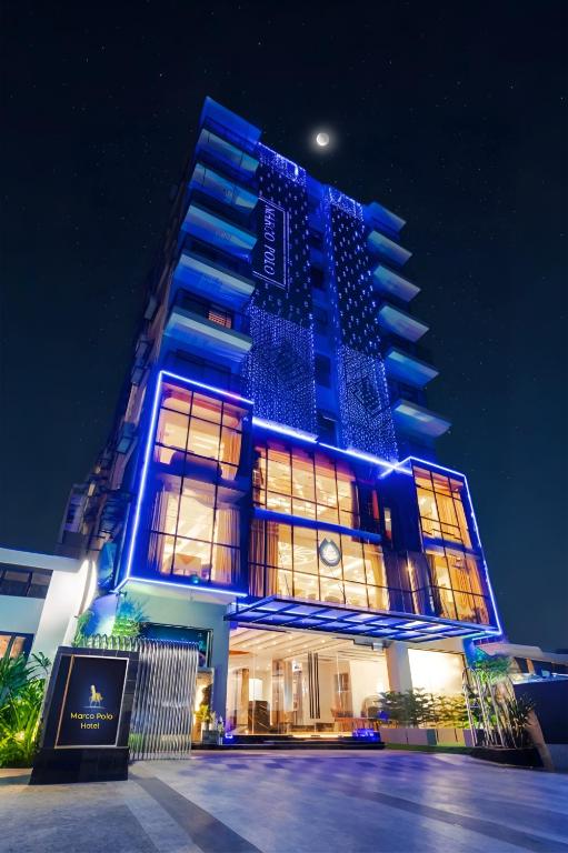 a building with blue lights on it at night at Marco Polo Dhaka in Dhaka