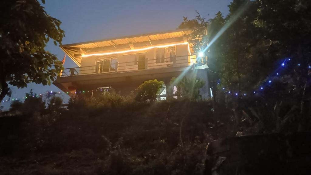 a house with lights on the side of it at night at Sayatri stay in Karsiyang