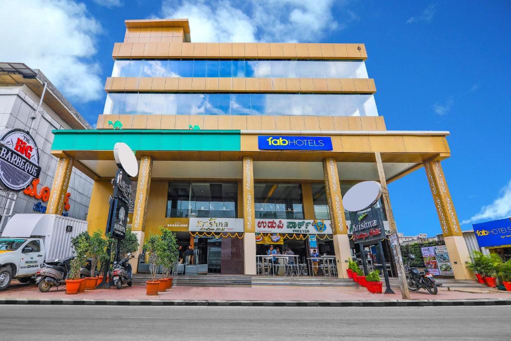 a building on a city street with a store at FabHotel High Rise Suites - Nr Marathahalli Bridge in Bengaluru