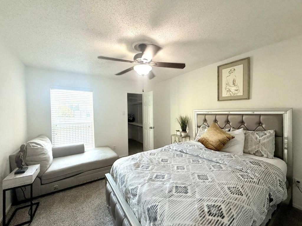a bedroom with a bed and a ceiling fan at Luxe, Family Friendly, Spacious & Private Entrance in Addison