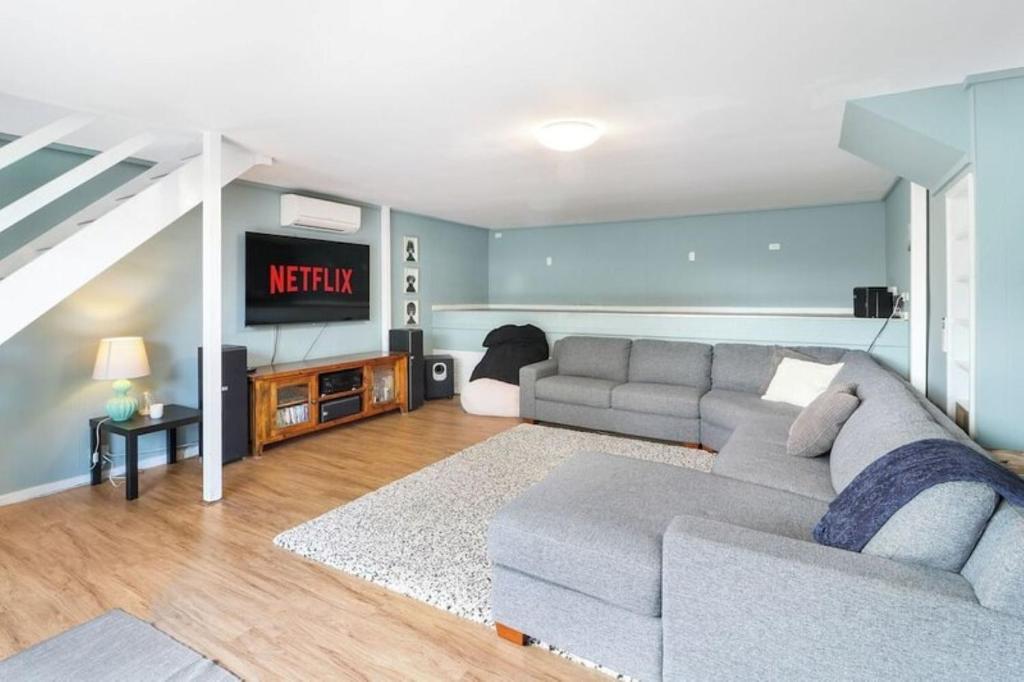 a living room with a couch and a television at Lakeview Retreat Bonnie Doon - Sleeps 12 in Bonnie Doon