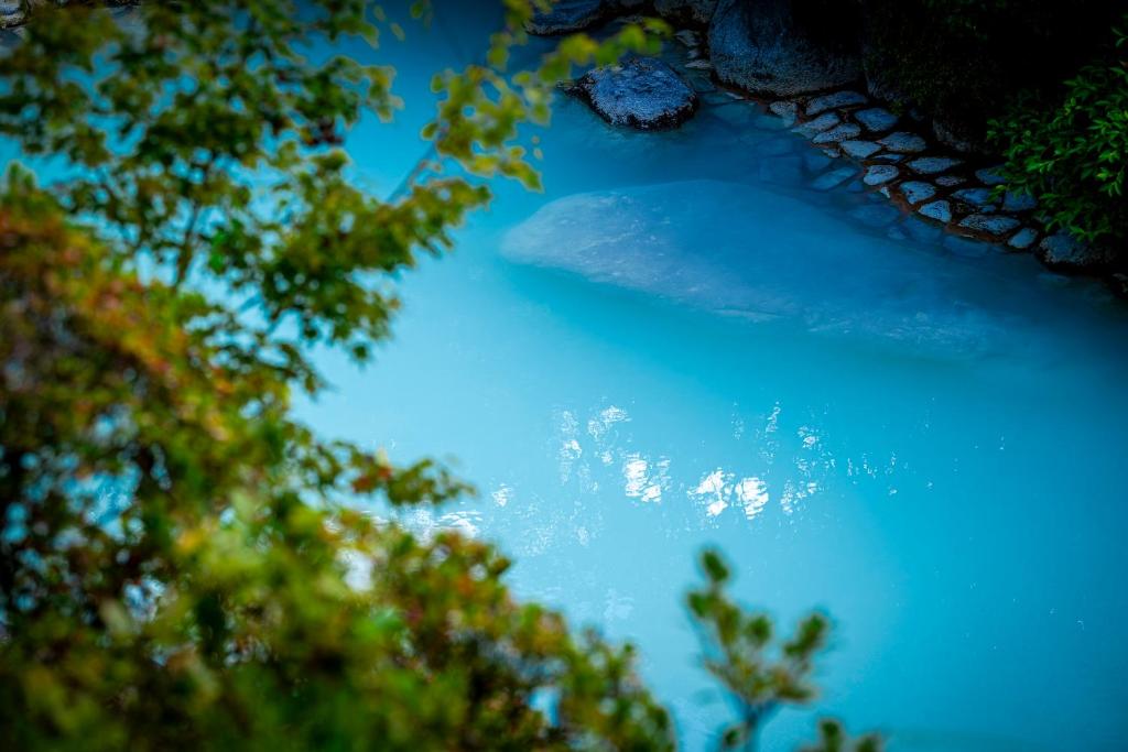 a view of a body of water with trees at Okamotoya in Beppu