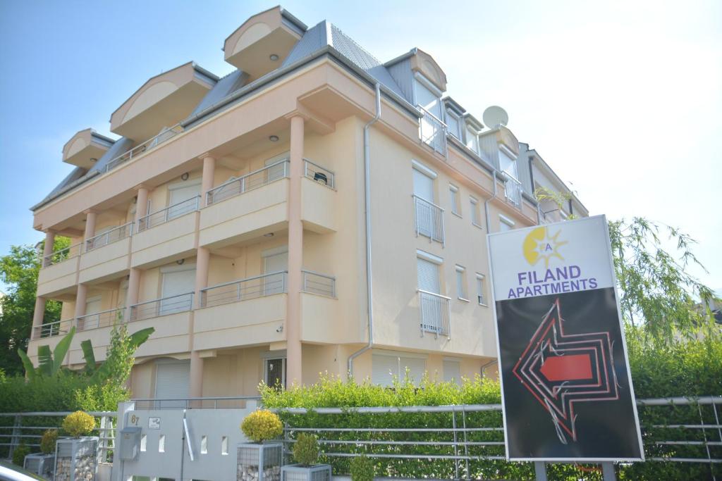 a large building with a sign in front of it at Filand Apartmani in Ohrid