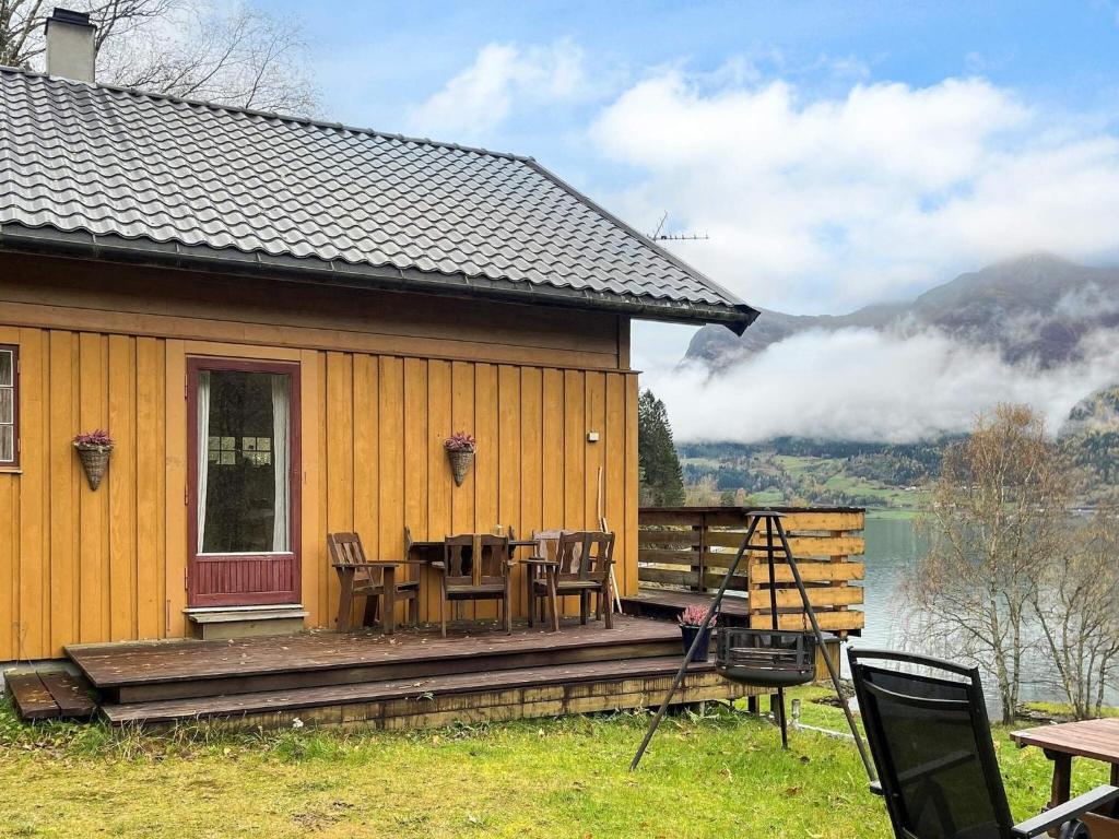 a house with a deck with a table and chairs at 7 person holiday home in STRYN-By Traum in Stryn