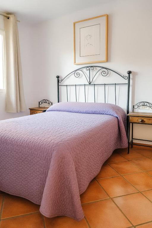 a bedroom with a bed with a pink blanket at Edelweiss con WIFI y parking in Sierra Nevada