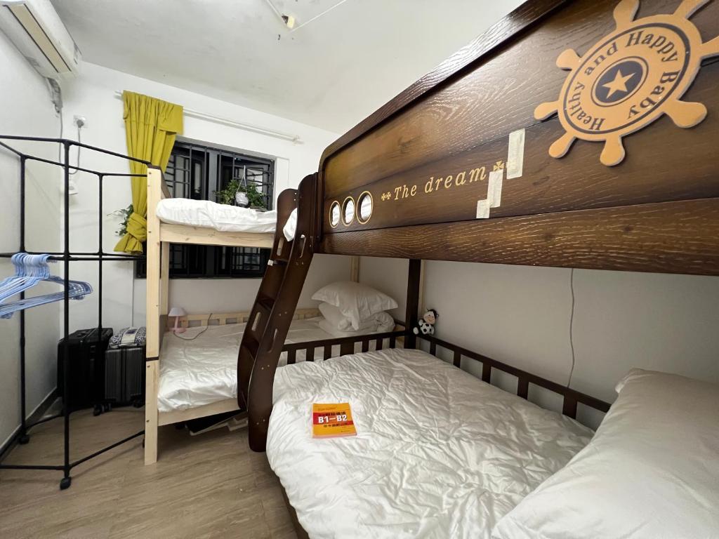 a dorm room with two bunk beds and a room with at Shenzhen Beacon Hostel in Shenzhen