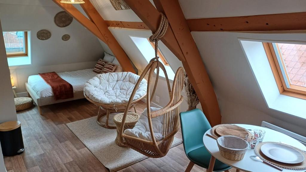 サントメールにあるStudio Bohème tout neufのブランコとベッドとテーブルのある部屋